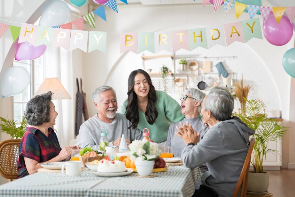 Group of Asian senior people having birthday party at home, celebrating birthday at retirement home with friends