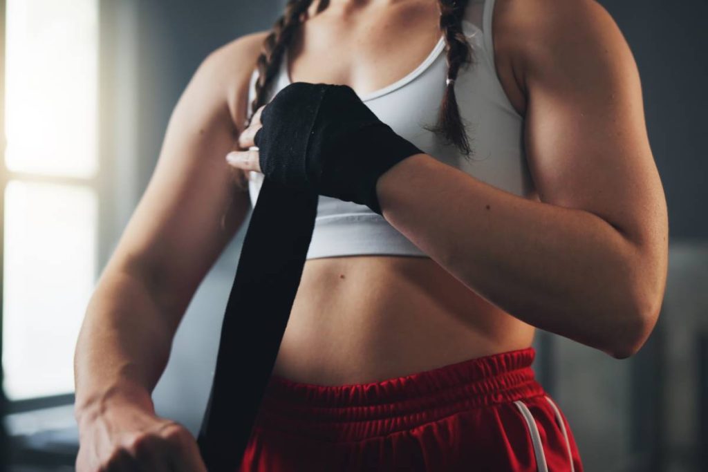 Hands, gym and boxing with training, wrapping and practice for match and sports with endurance. female’s Muay Thai.